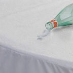 Waterproof mattress protector with water spill
